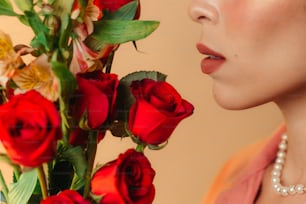 a close up of a woman's face next to a bouquet of roses