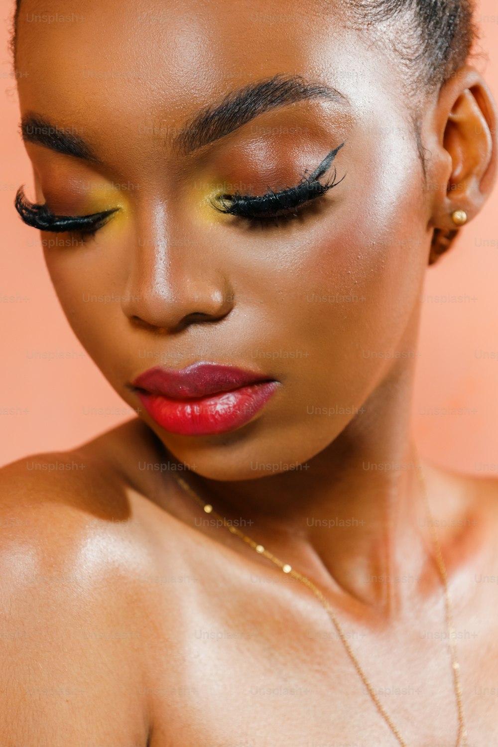 a woman with a red lipstick and black lashes