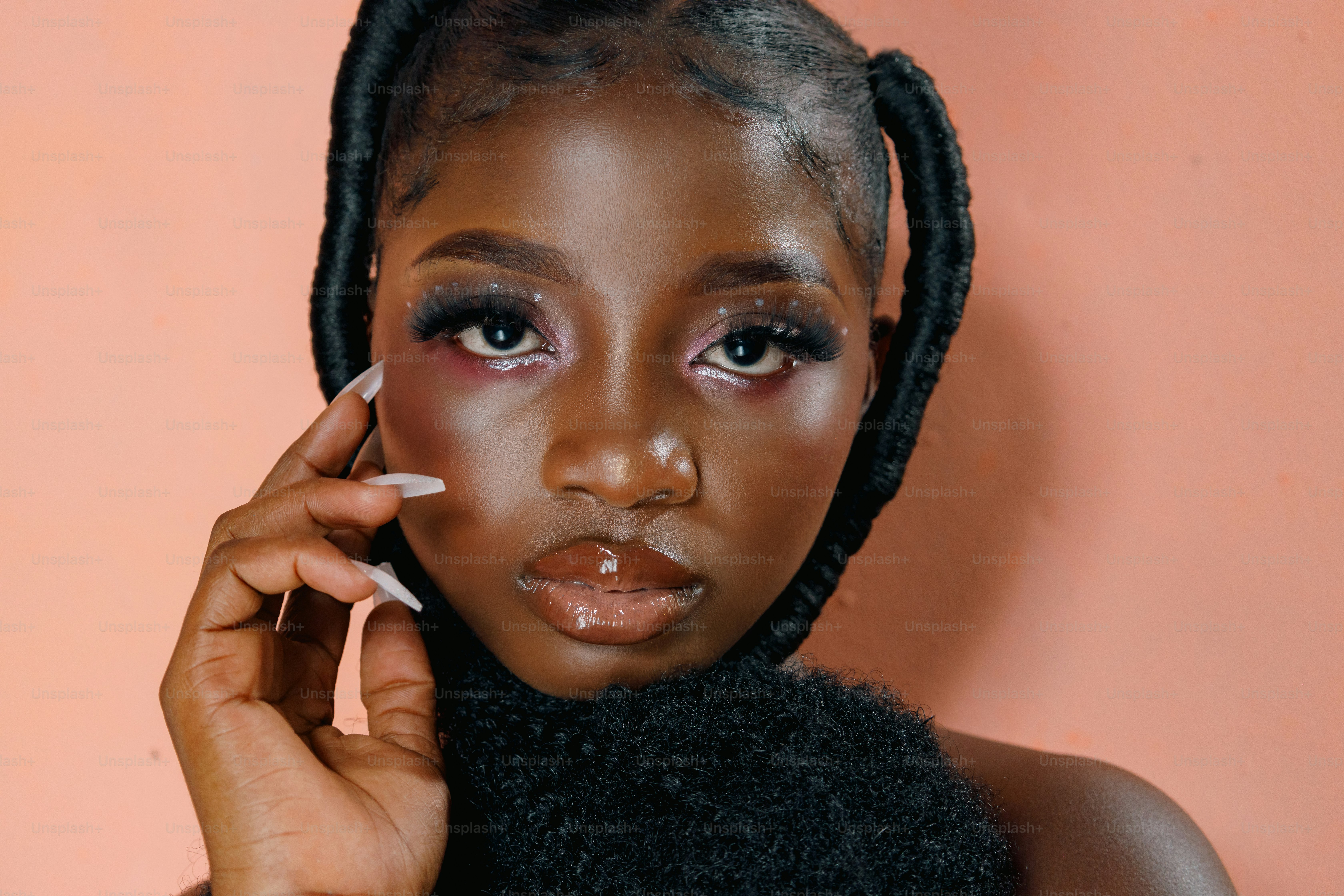 a woman with braids holding a cigarette in her hand
