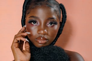 a woman with braids holding a cigarette in her hand