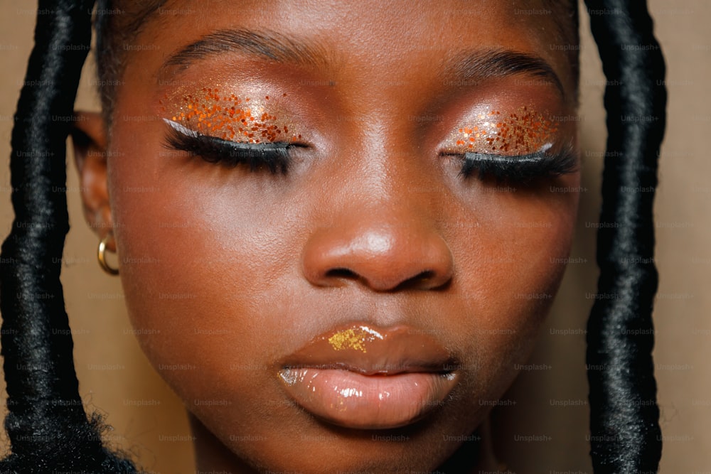a young girl with gold glitter on her eyes