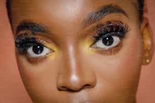 a close up of a woman's face with long lashes