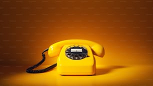 a yellow telephone sitting on top of a table