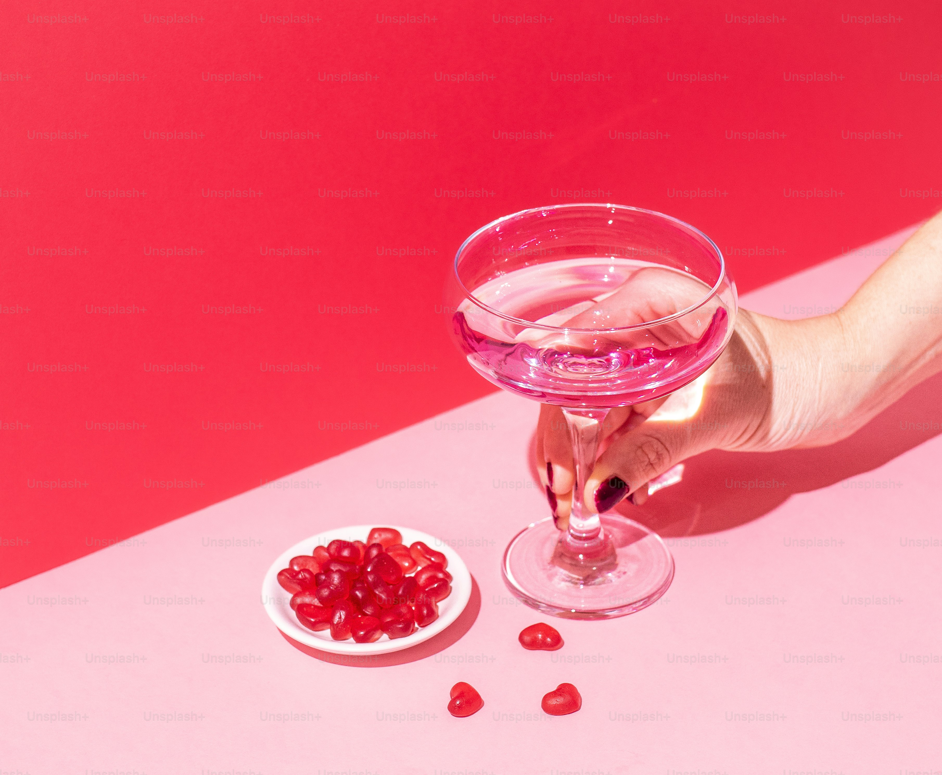 a person holding a wine glass filled with liquid