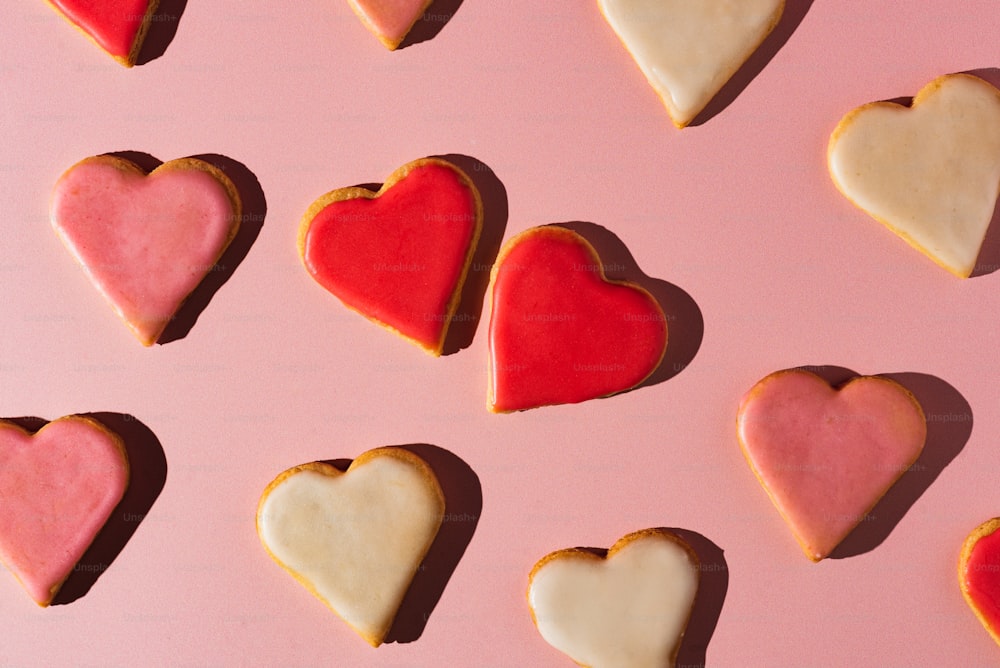 heart shaped cookies arranged on a pink surface