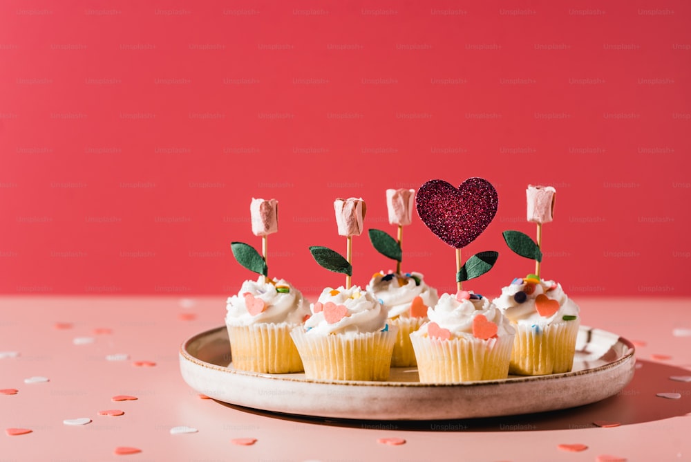Cupcakes mit Marshmallows und Streuseln auf einem Teller
