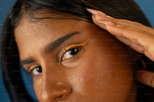 a close up of a person with a yellow eyeliner