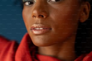 a close up of a woman wearing a red shirt