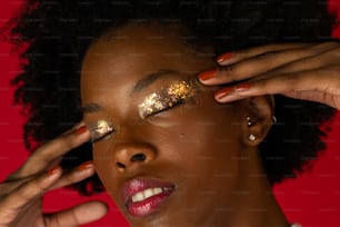 a woman with gold glitter on her eyes