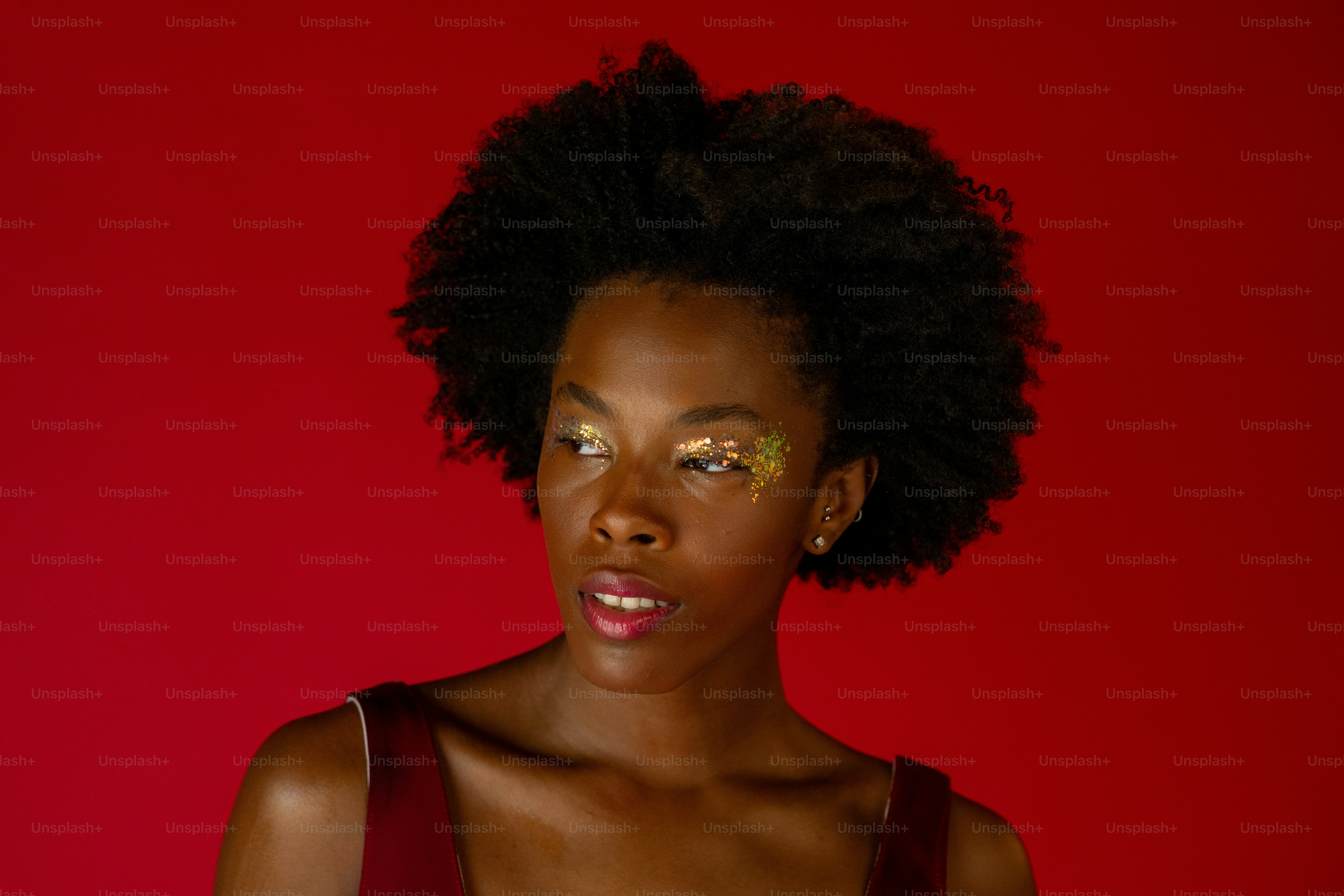 A woman with a red dress and gold eye makeup photo  Beauty Image on  Unsplash