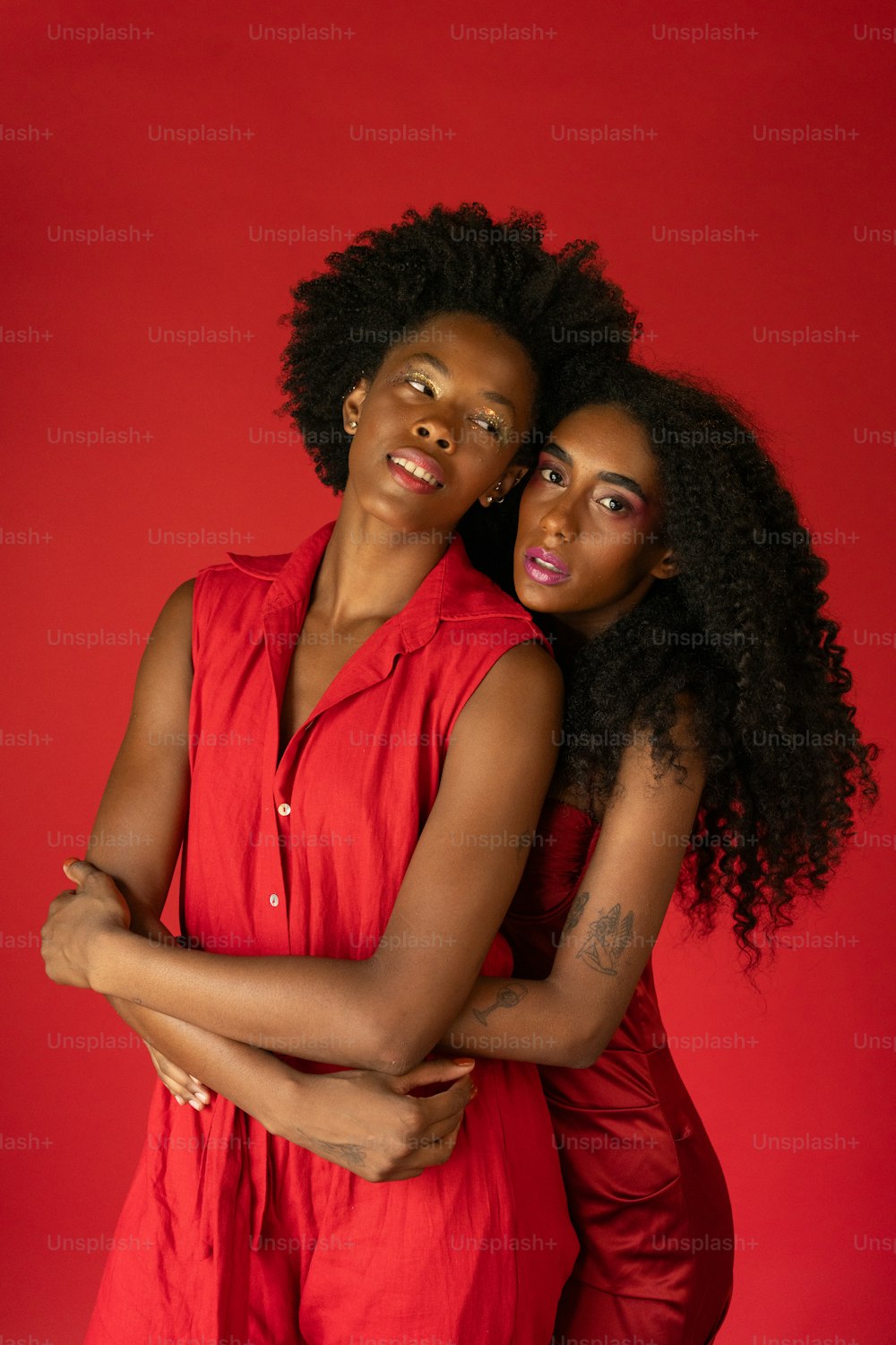 two women in red posing for a picture