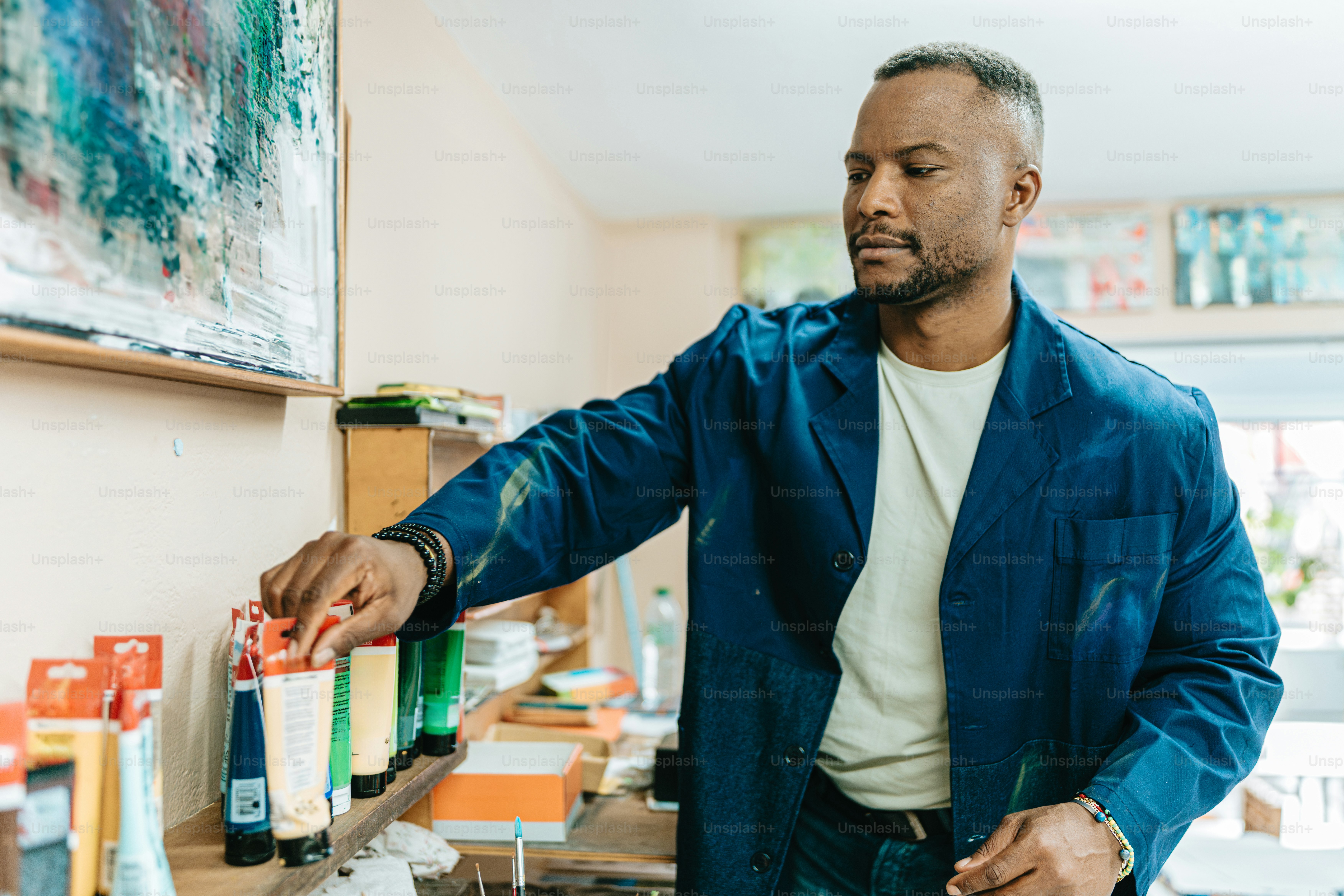 a man in a blue jacket is holding a bottle of wine