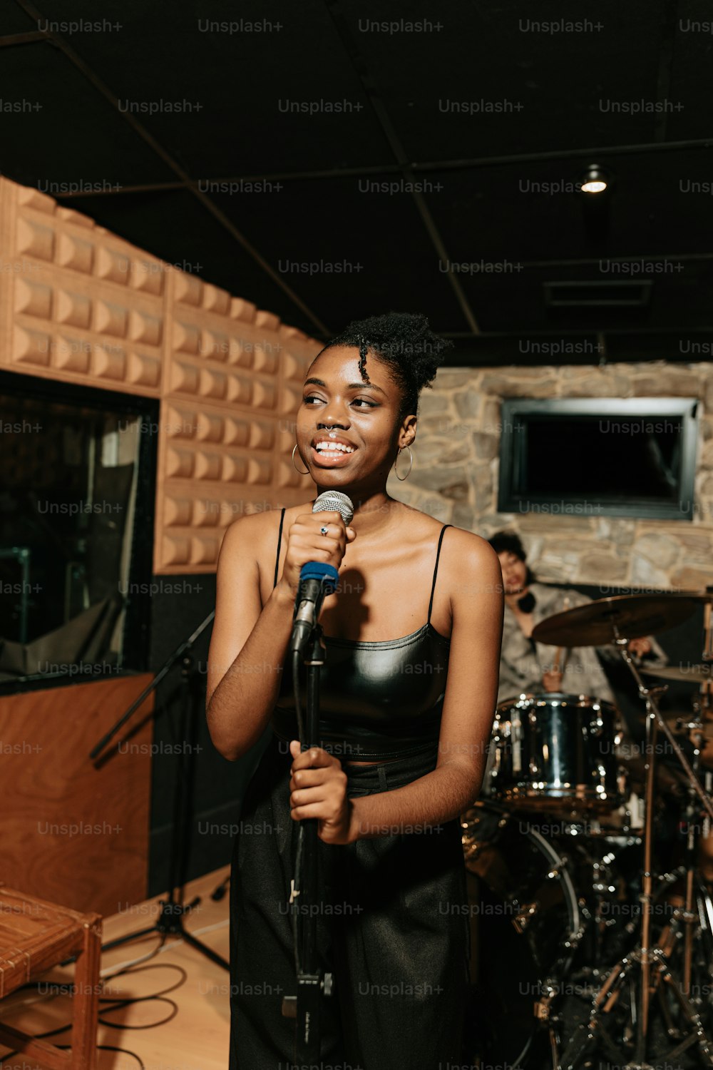 a woman standing in front of a microphone