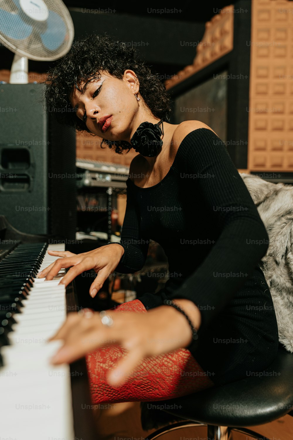 a woman sitting at a piano in a room