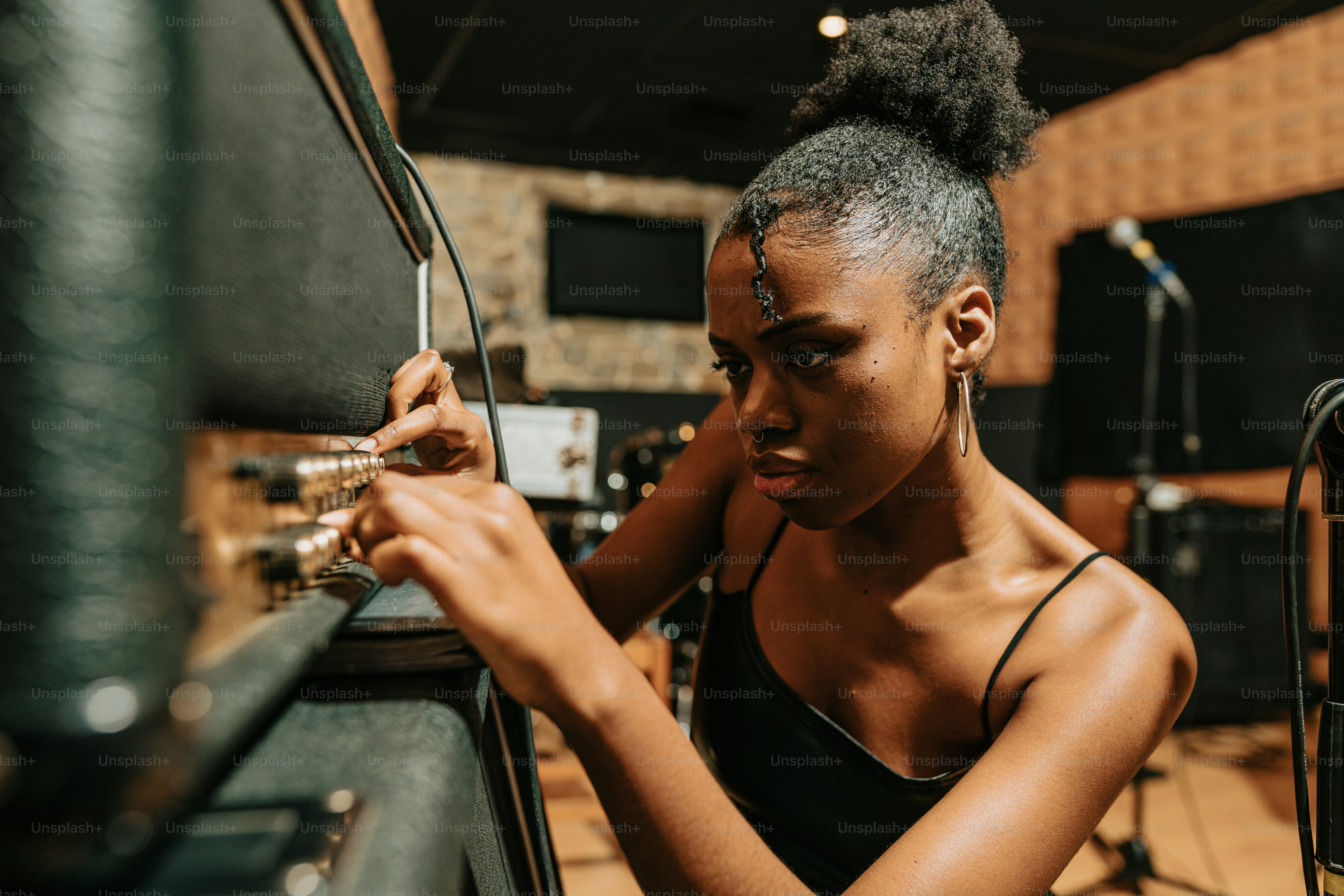 a woman in a recording studio working on a project