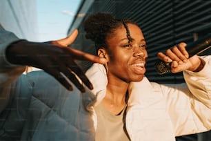 a woman holding a microphone up to her ear