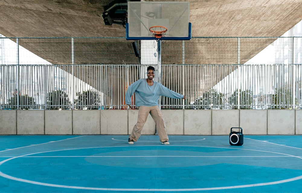 a man standing on a basketball court holding a basketball