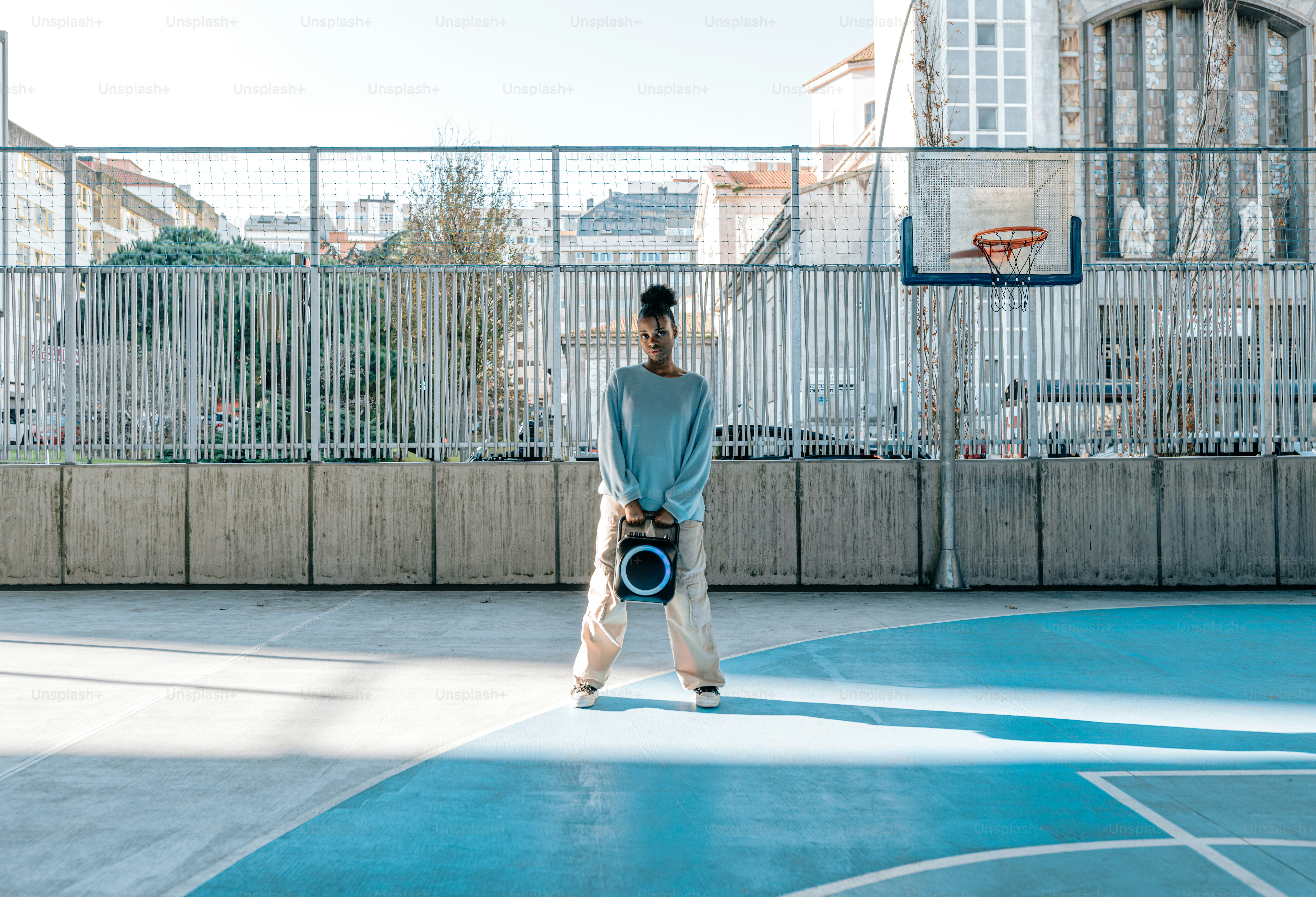 a man standing on a basketball court holding a ball