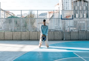 a man standing on a basketball court holding a ball