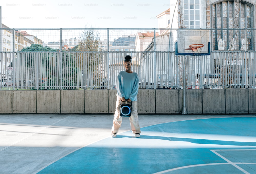 a man standing on a basketball court holding a ball