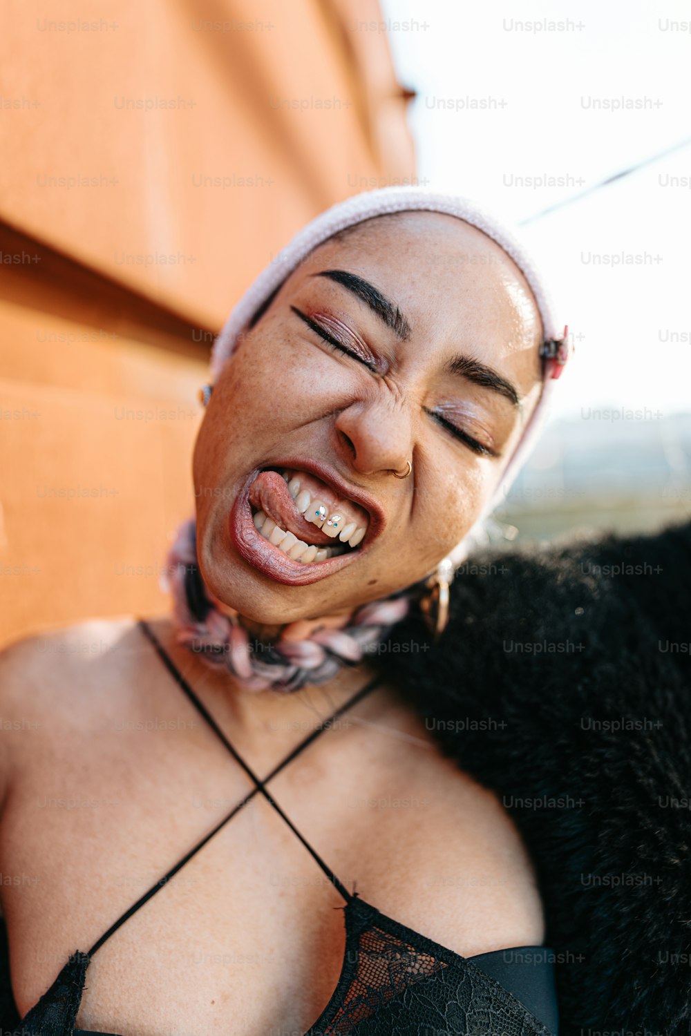 a woman with a scarf around her head laughing