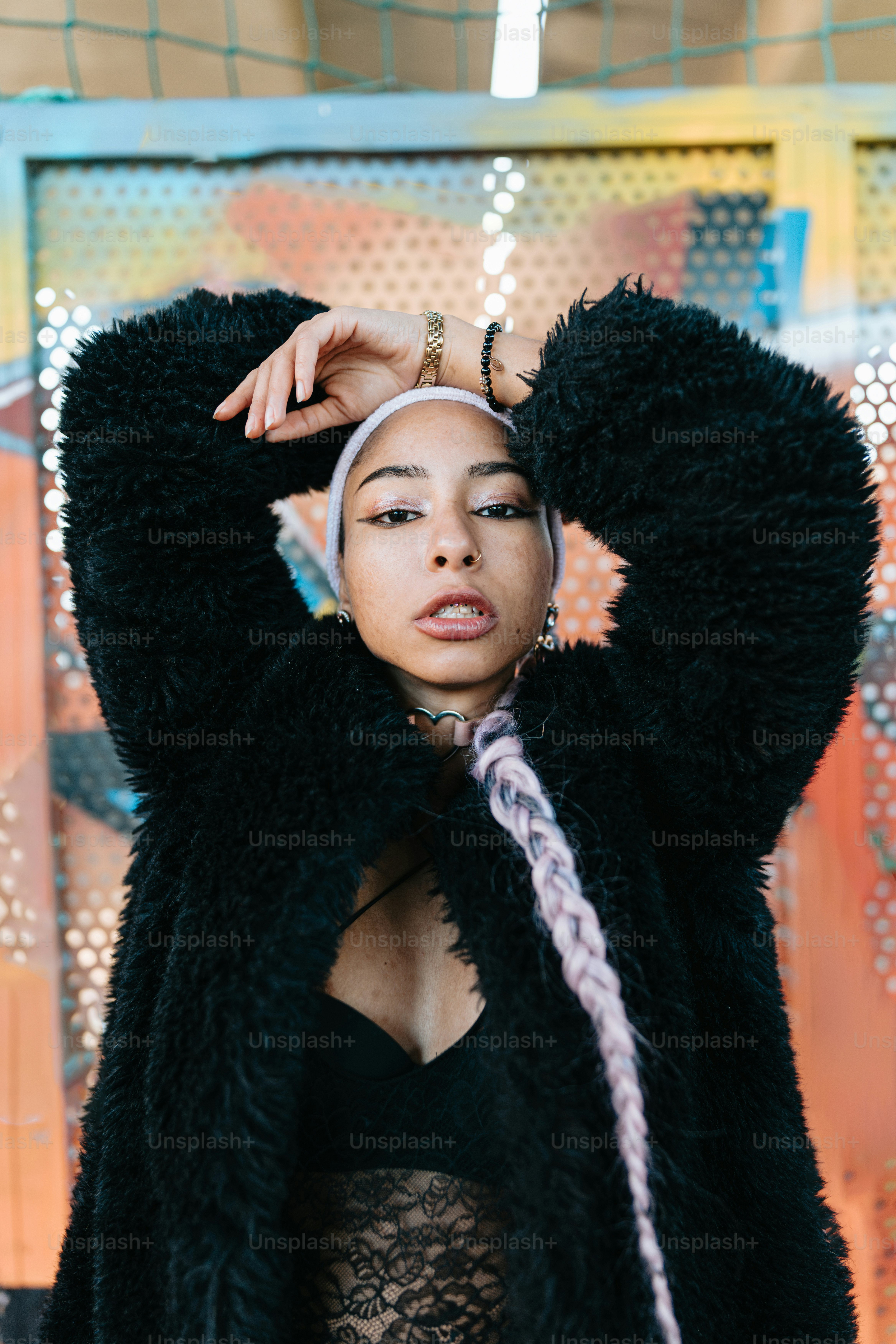 a woman wearing a black jacket and a white headband