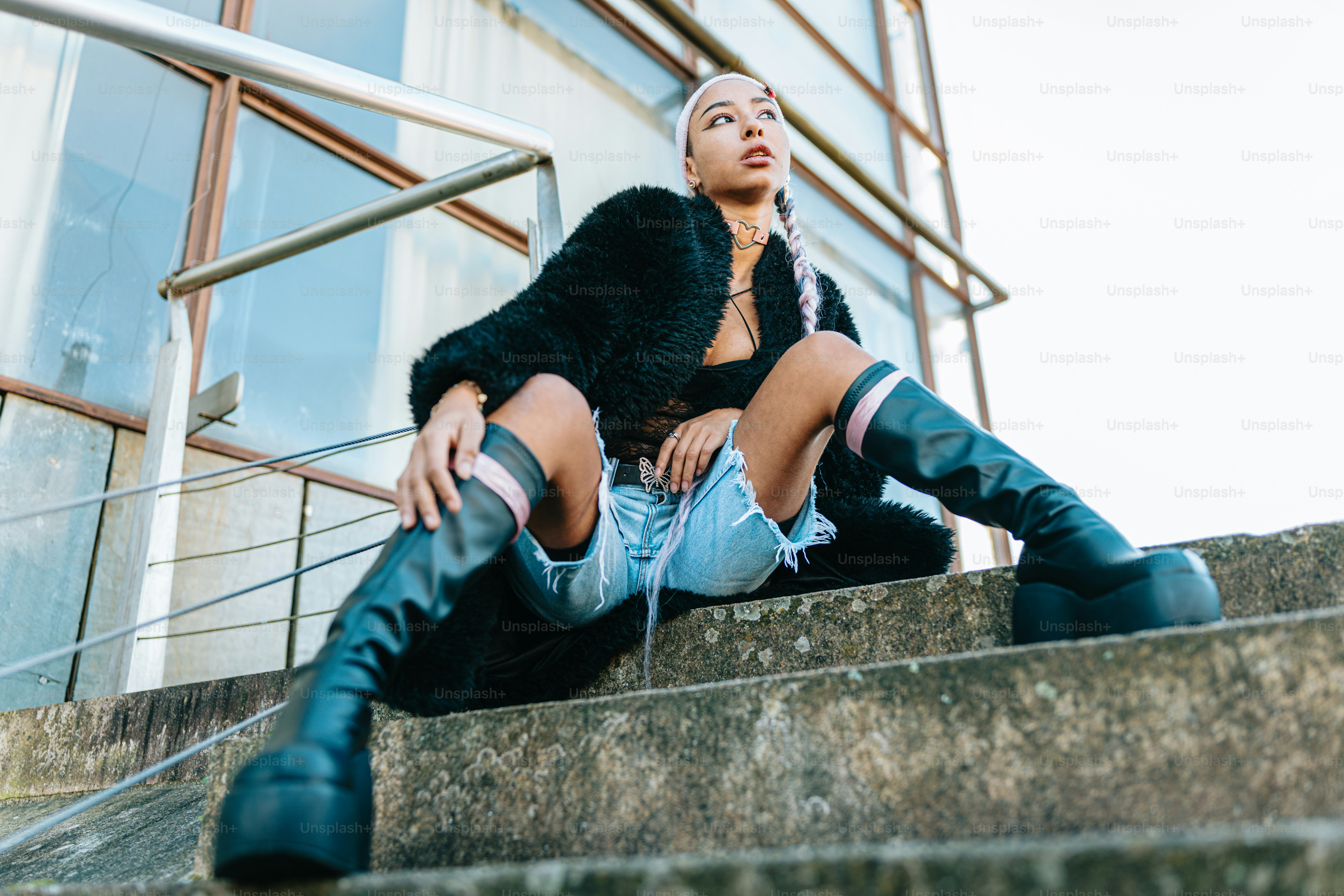 a woman sitting on the steps of a building