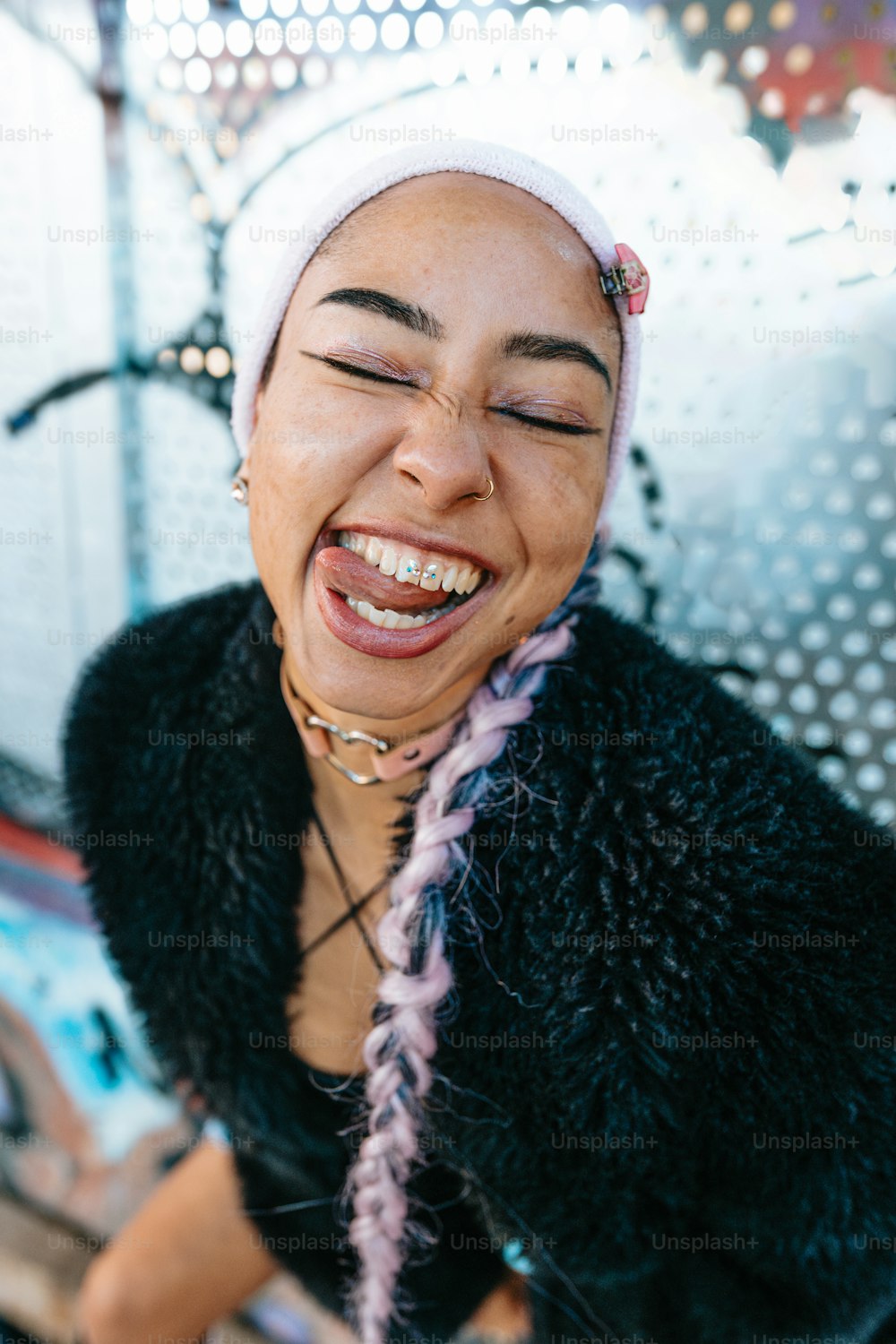 a woman with her eyes closed laughing