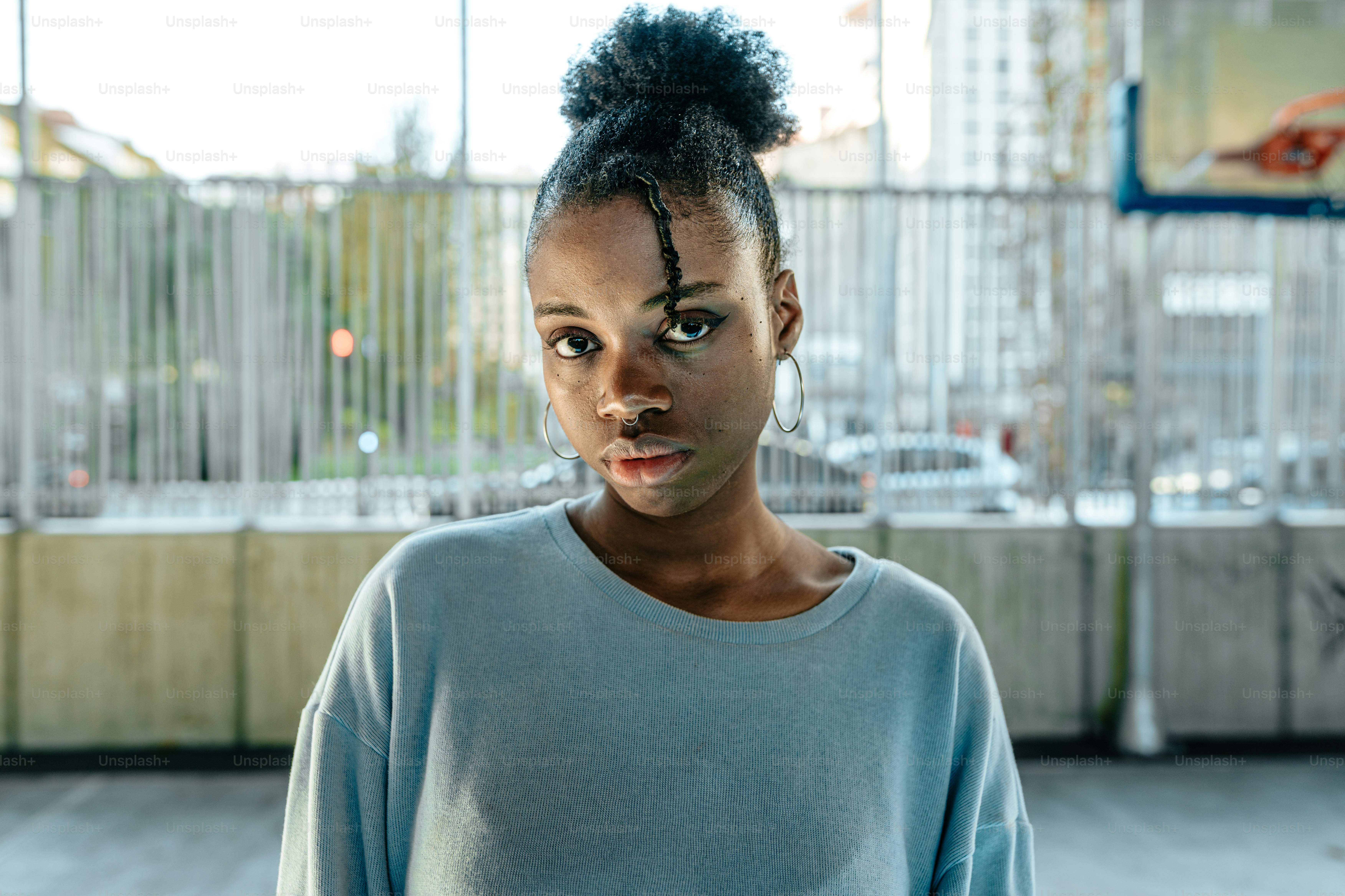 a woman standing in front of a window with a surprised look on her face