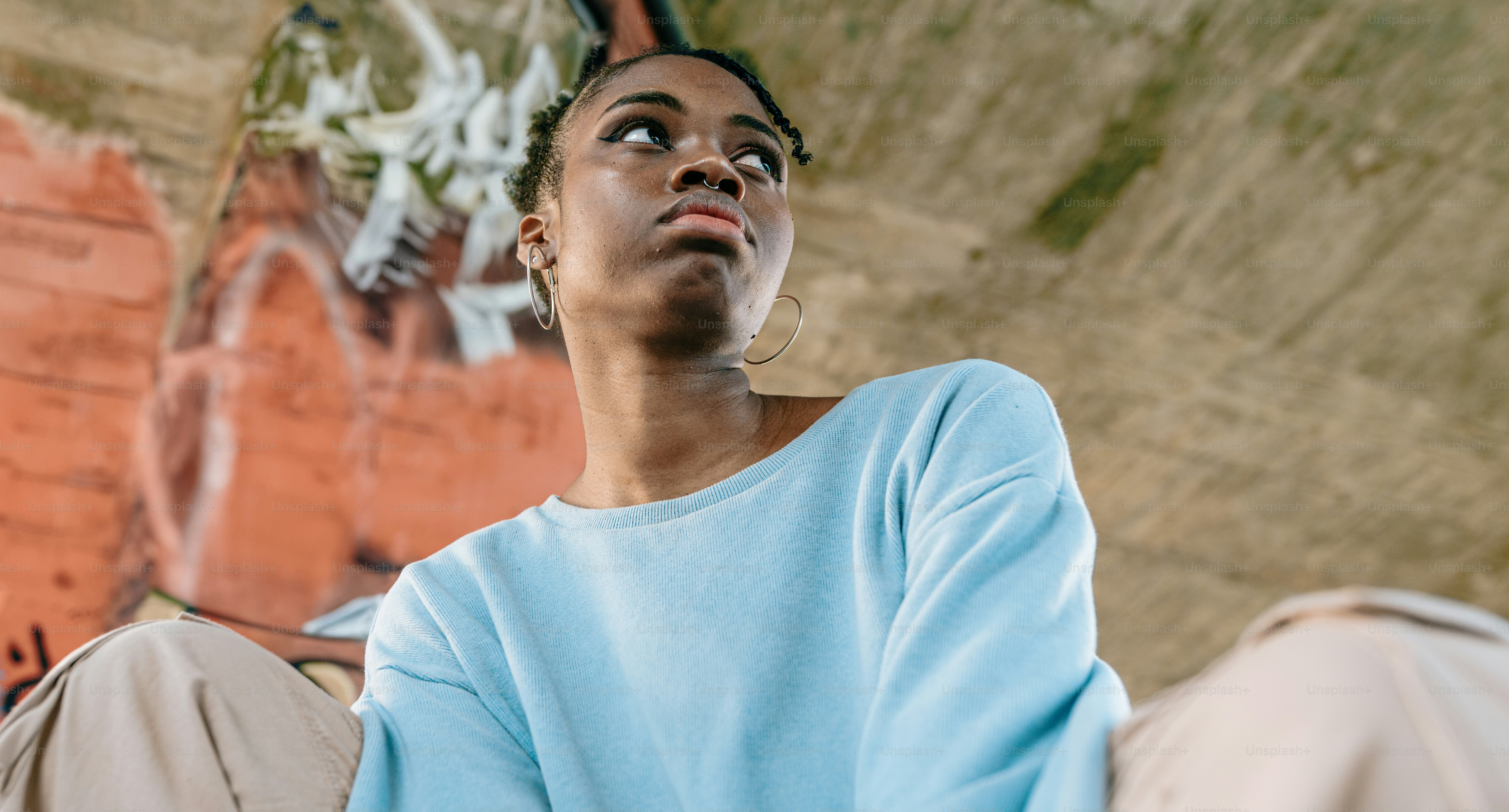 a woman sitting on the ground looking up