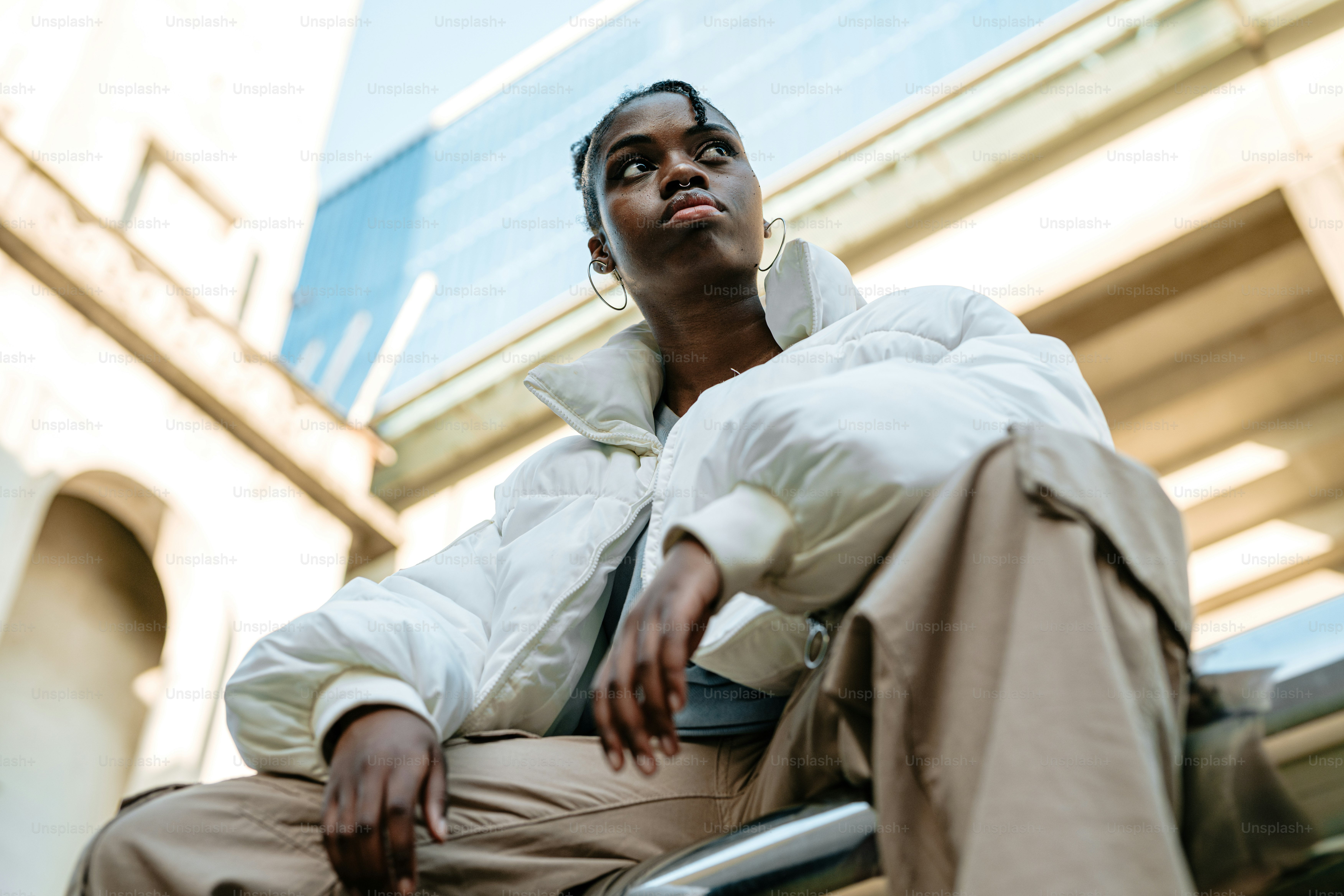 a man sitting on a bench in front of a building