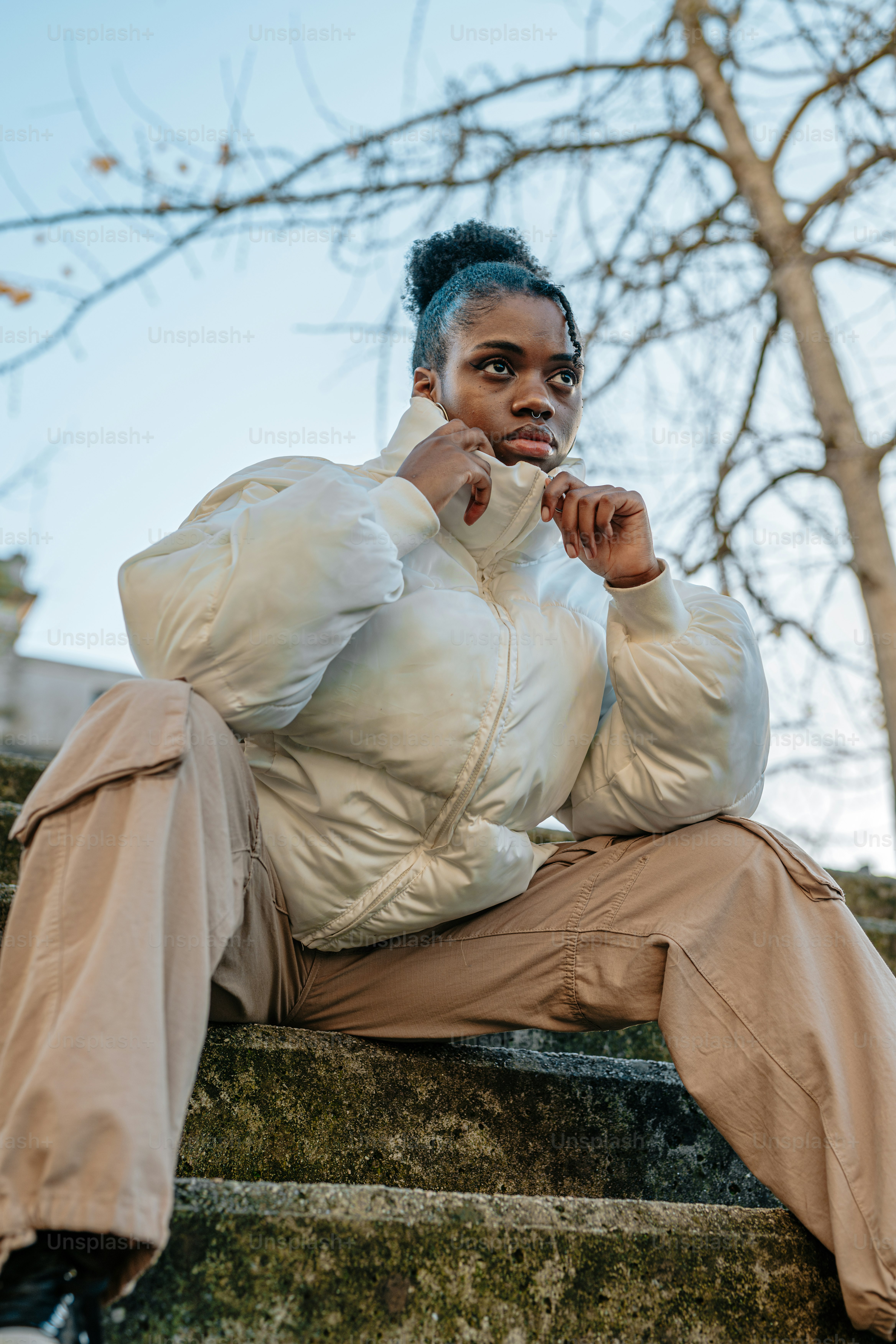 a woman is sitting on a set of stairs