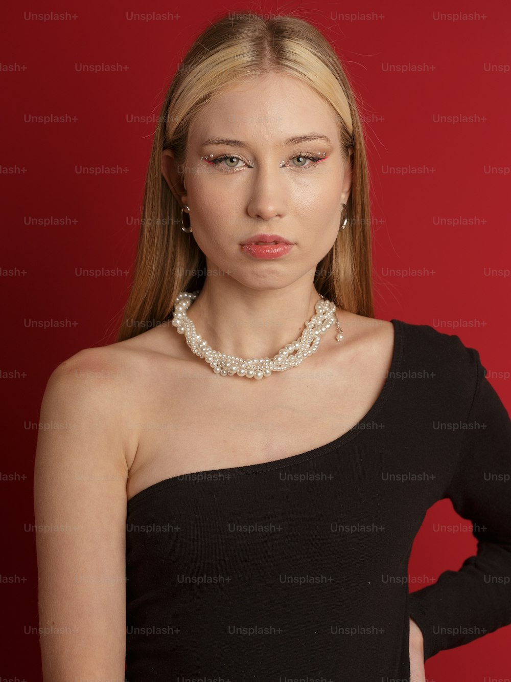 a woman in a black dress wearing a necklace