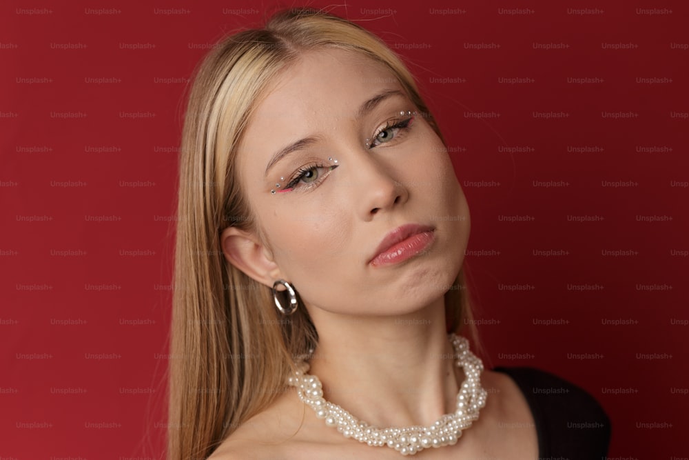 a woman wearing a pearl necklace and earrings