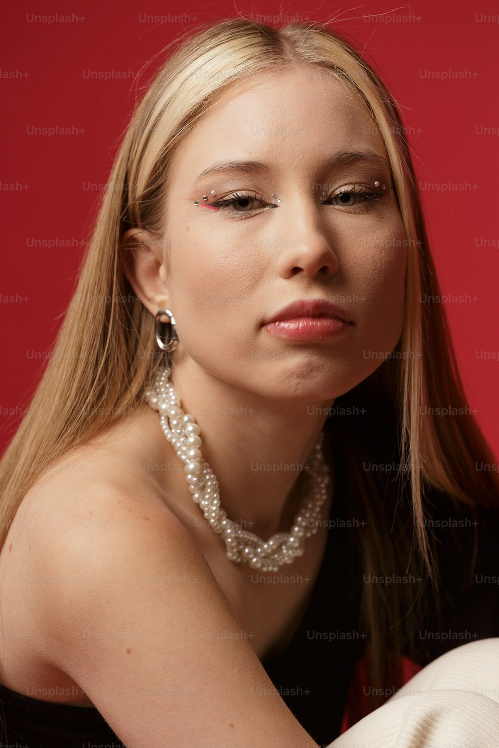 a woman with a pearl necklace and pearls on her neck