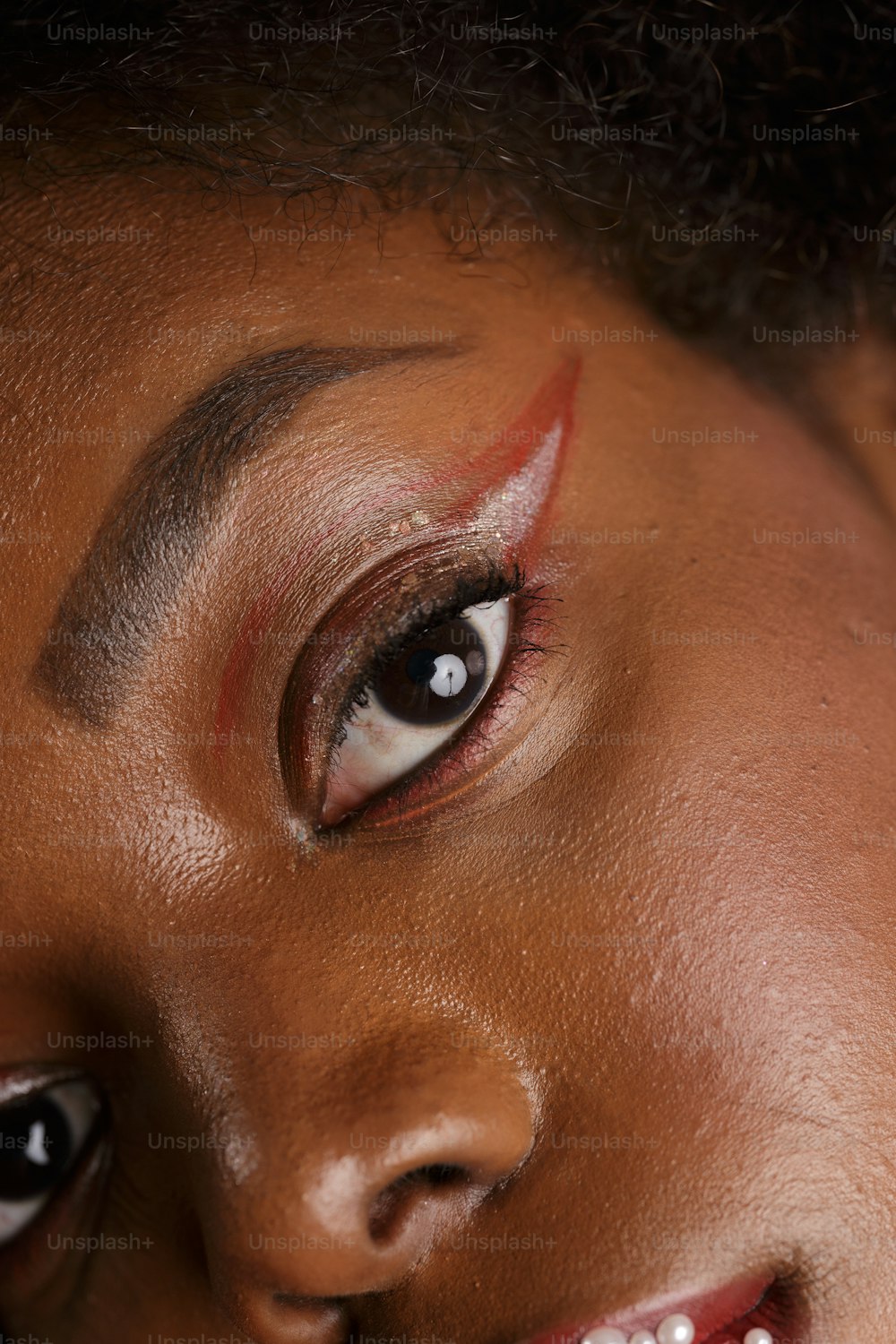 a close up of a woman's face with makeup