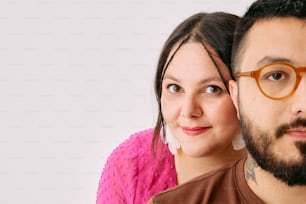 a man and a woman are posing for a picture