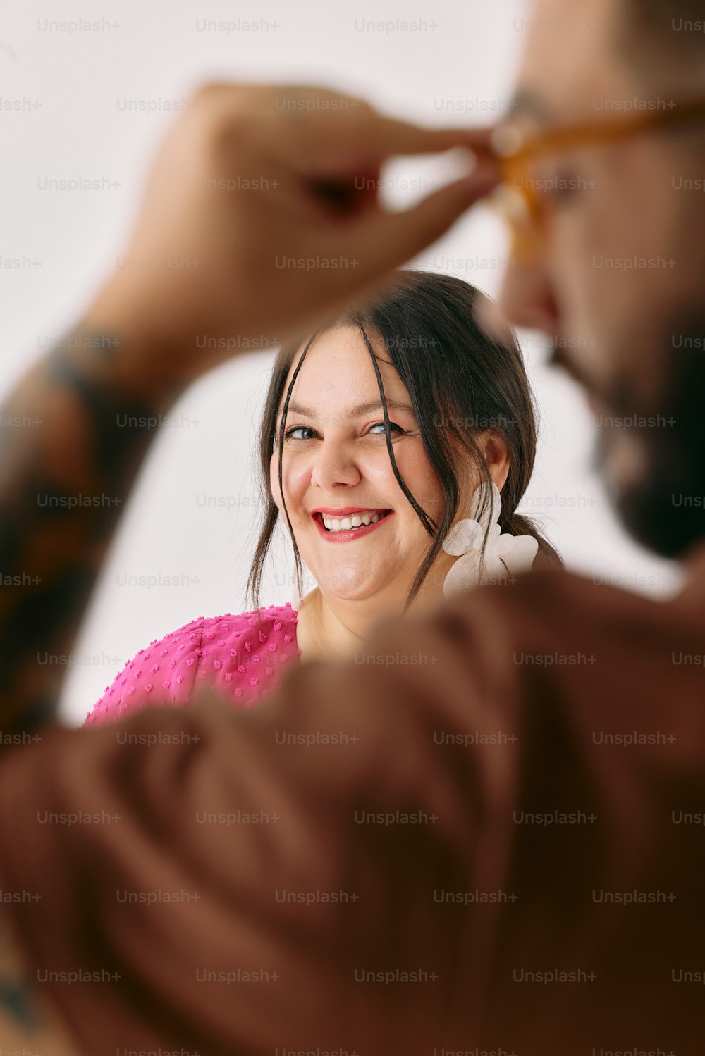 a woman is smiling while looking in the mirror