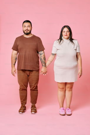 Ein Mann und eine Frau halten Händchen vor rosa Hintergrund