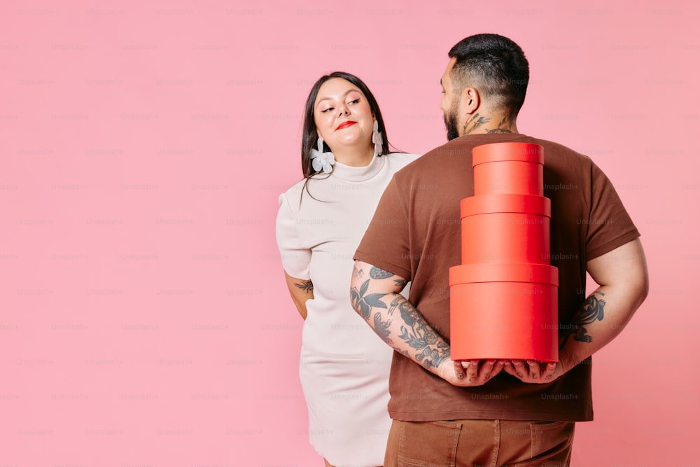 a man and a woman holding a large red object