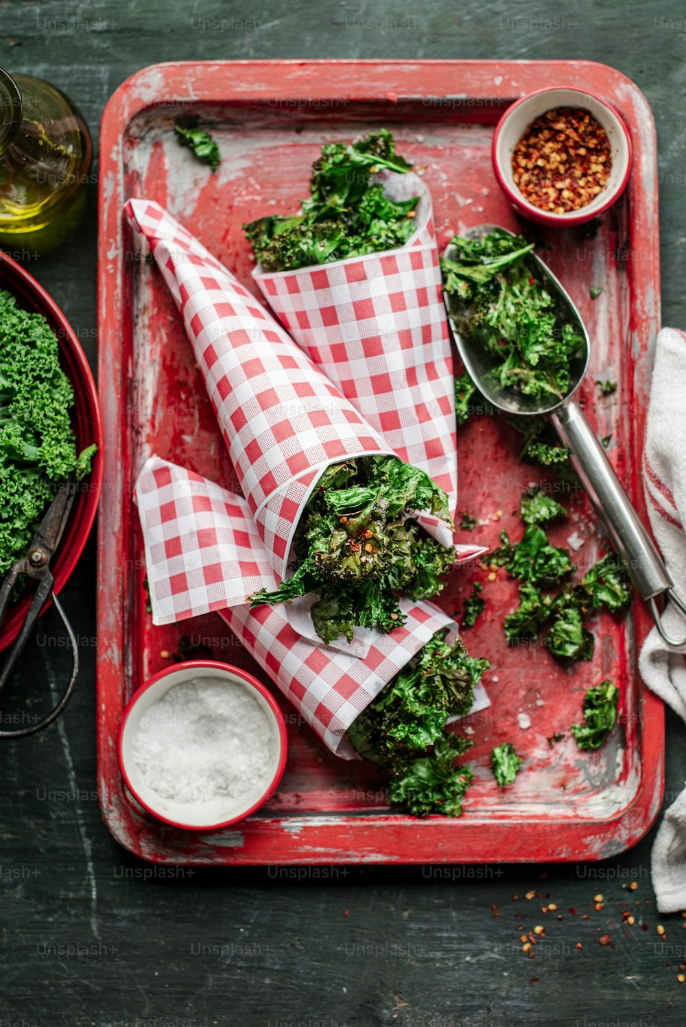 a red tray topped with broccoli covered in sauce