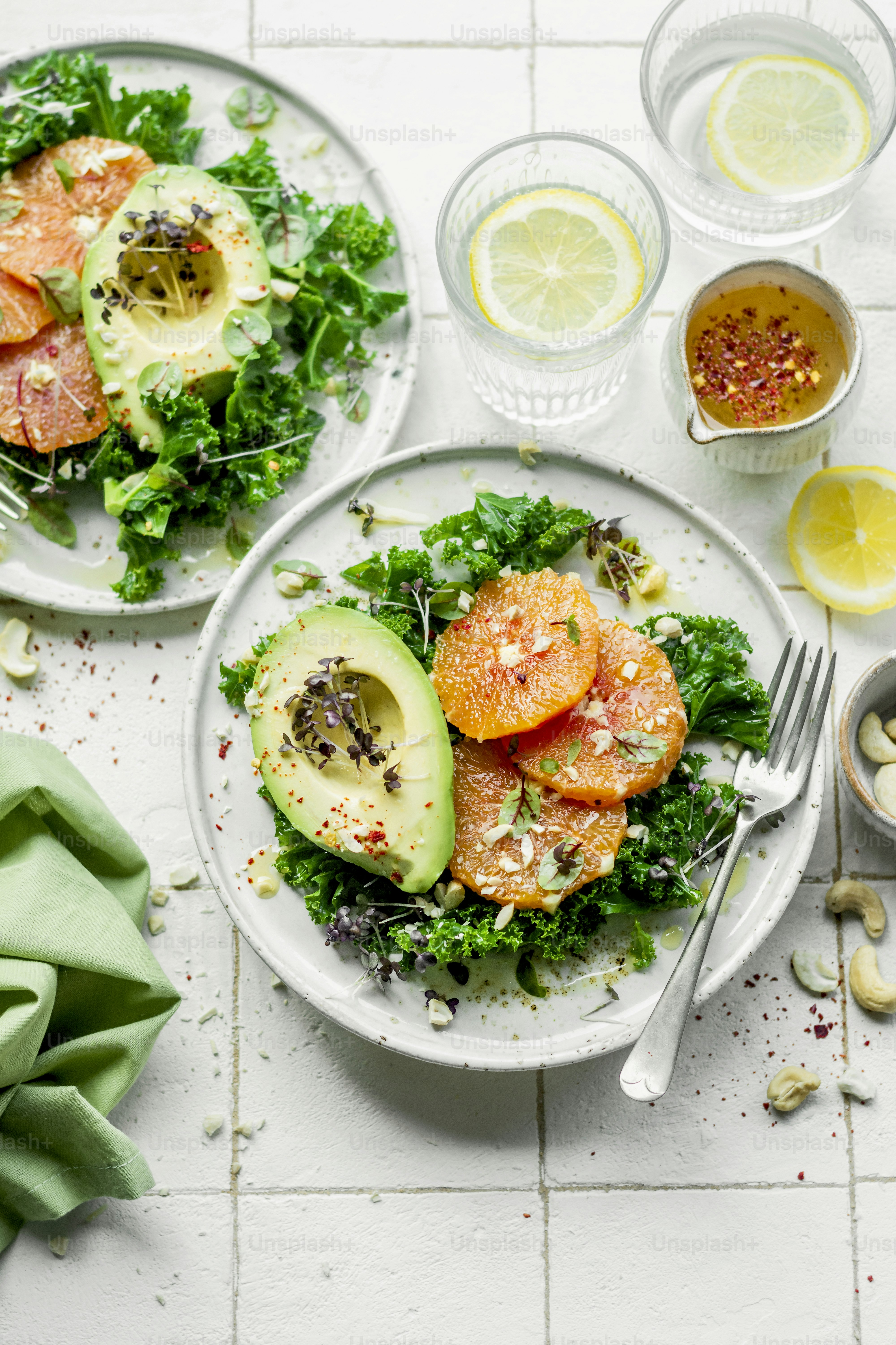 two plates of food with avocado and tomatoes