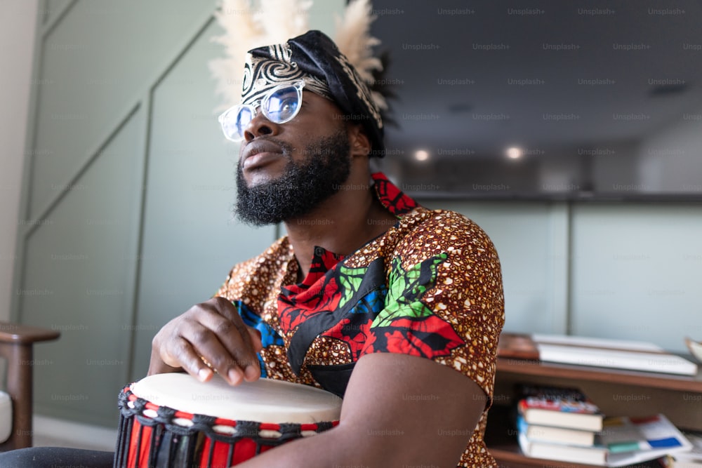 a man in a colorful shirt playing a drum