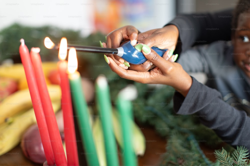 a child lighting a candle with a stick