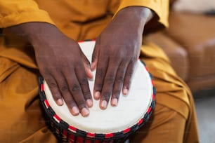 a close up of a person holding a drum