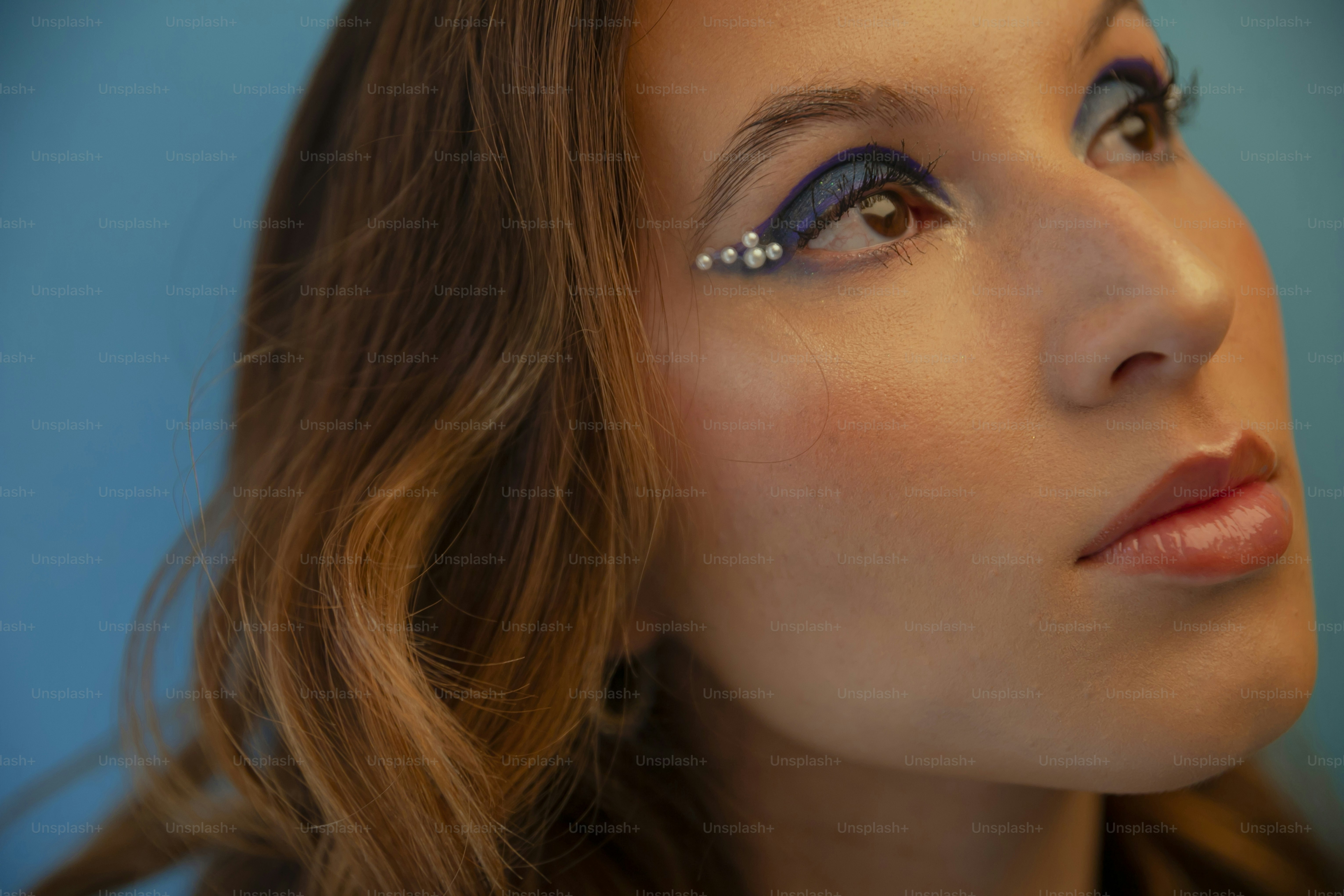 A close up of a woman with blue eye makeup photo – Cosmetics Image on ...