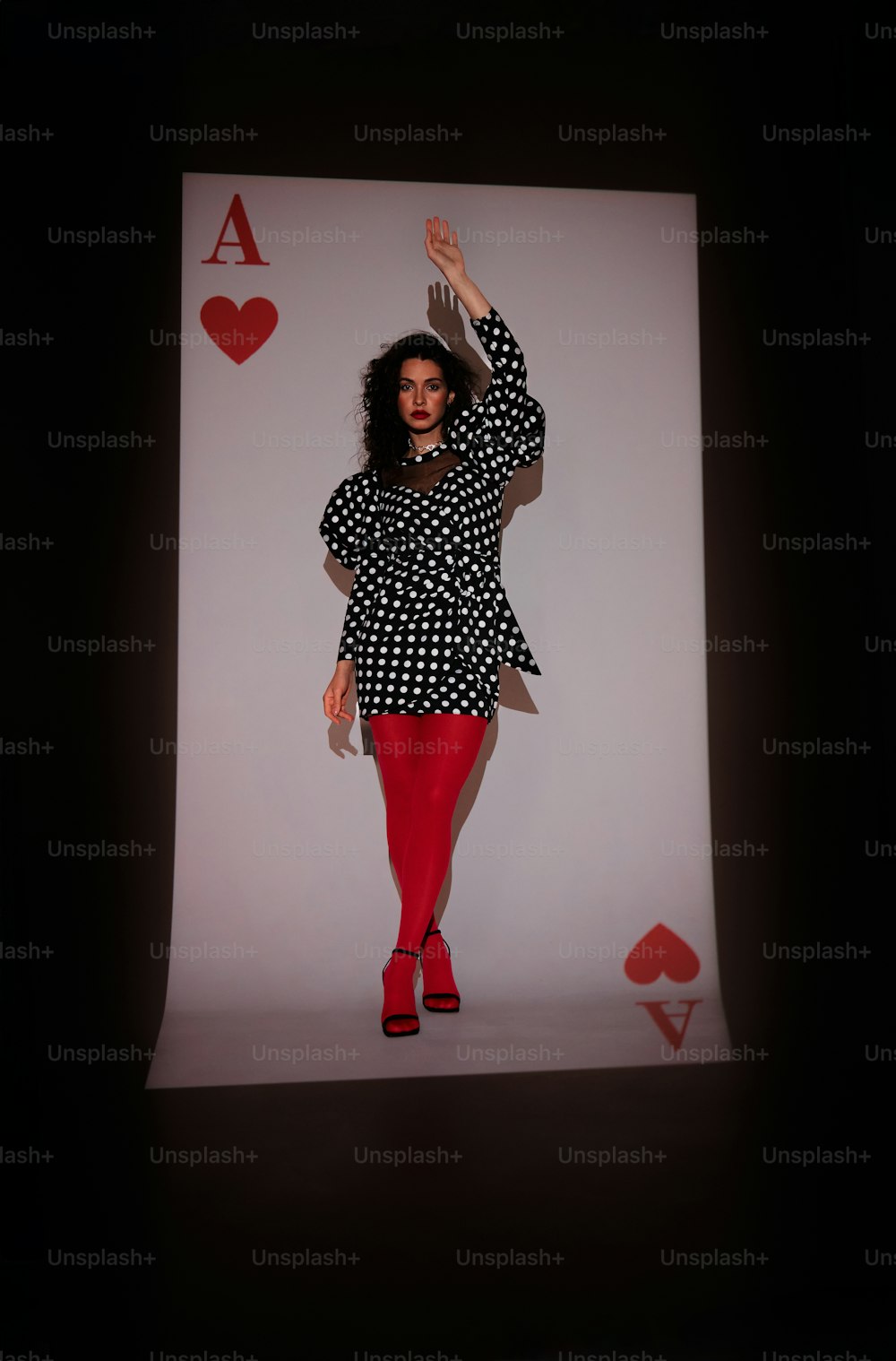 a woman in a black and white dress and red tights