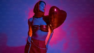 a woman in a bikini holding a balloon and a heart shaped balloon