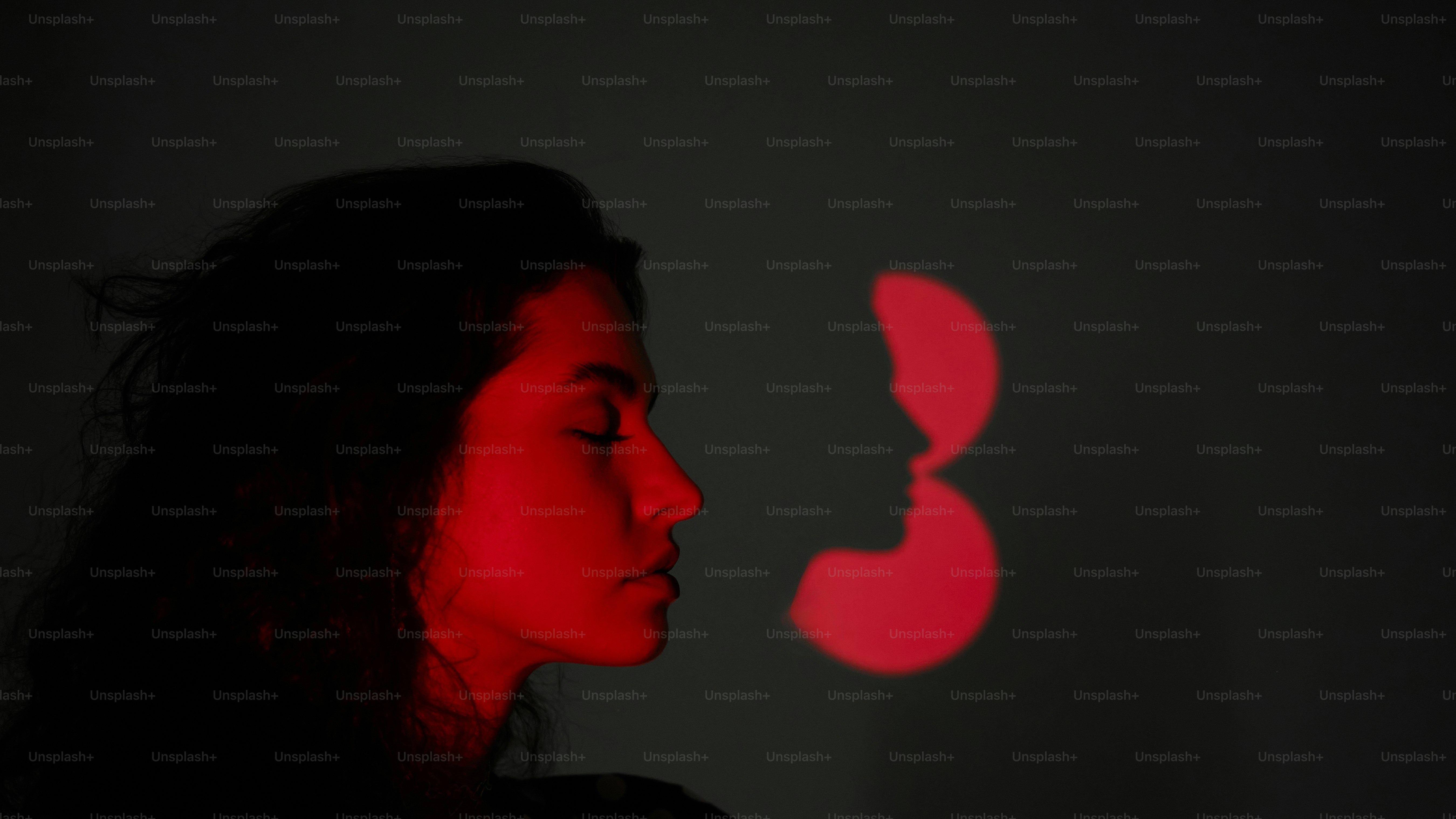 a woman standing in front of a red light