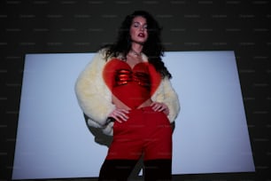 a woman in a red top and black pants